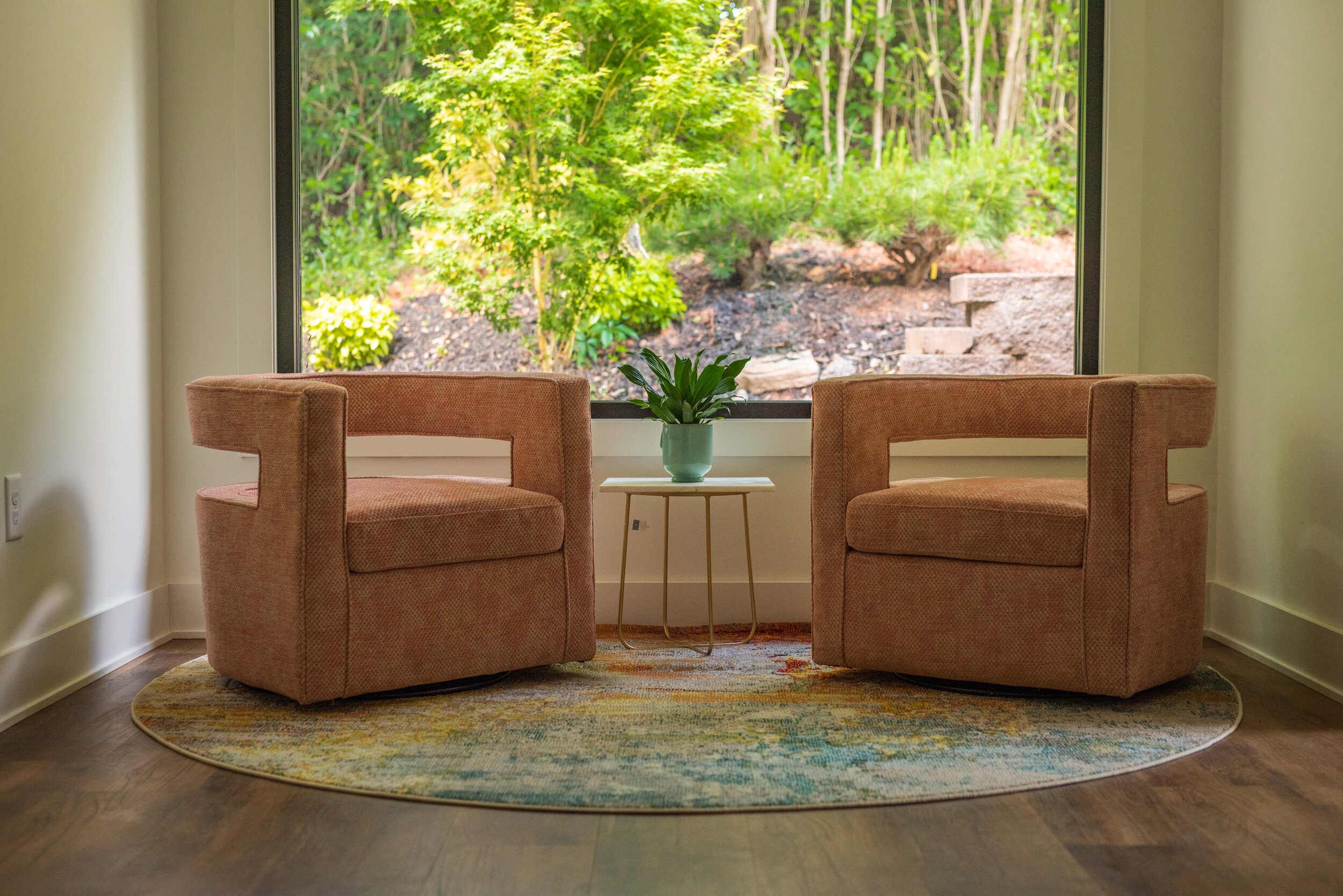 Two chairs in the Career Harmony Lounge beside a sunlit window